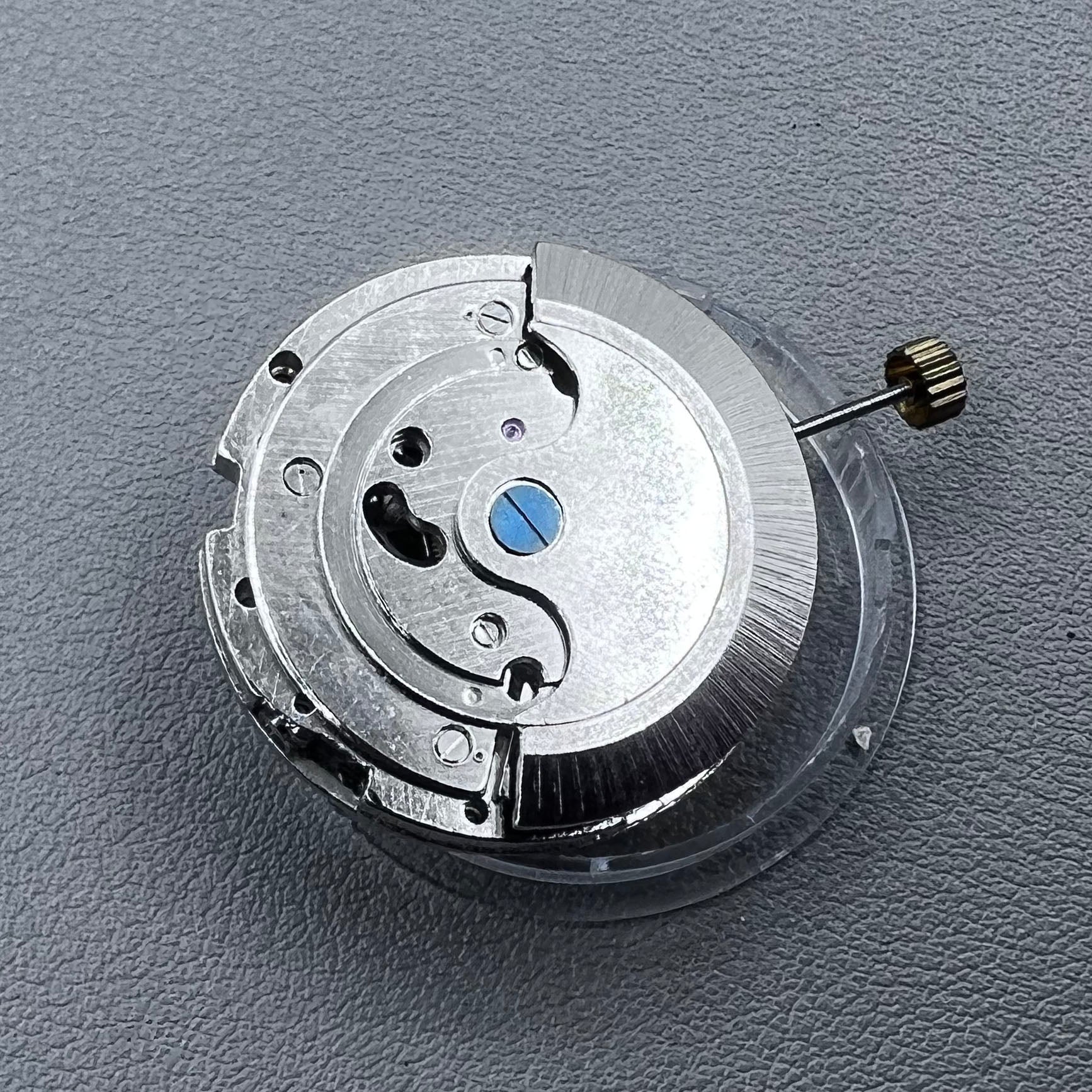 China multifunctional automatic watch with mechanical movement, moon phase at 12 o?clock, and visible flywheel detail