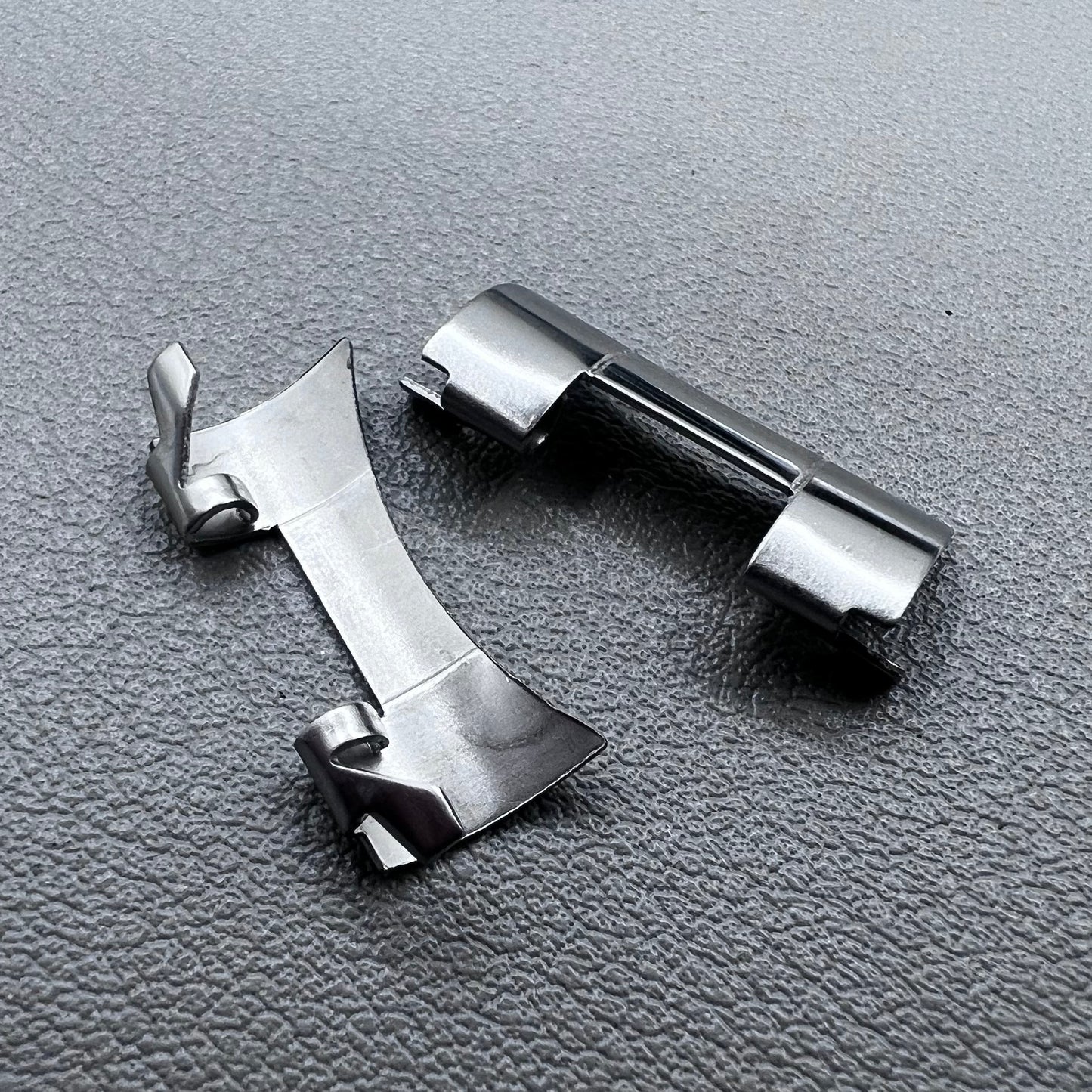 Set of 2 stainless steel 20x9mm curved end links and spring bars for watch bands, compatible with various straps.