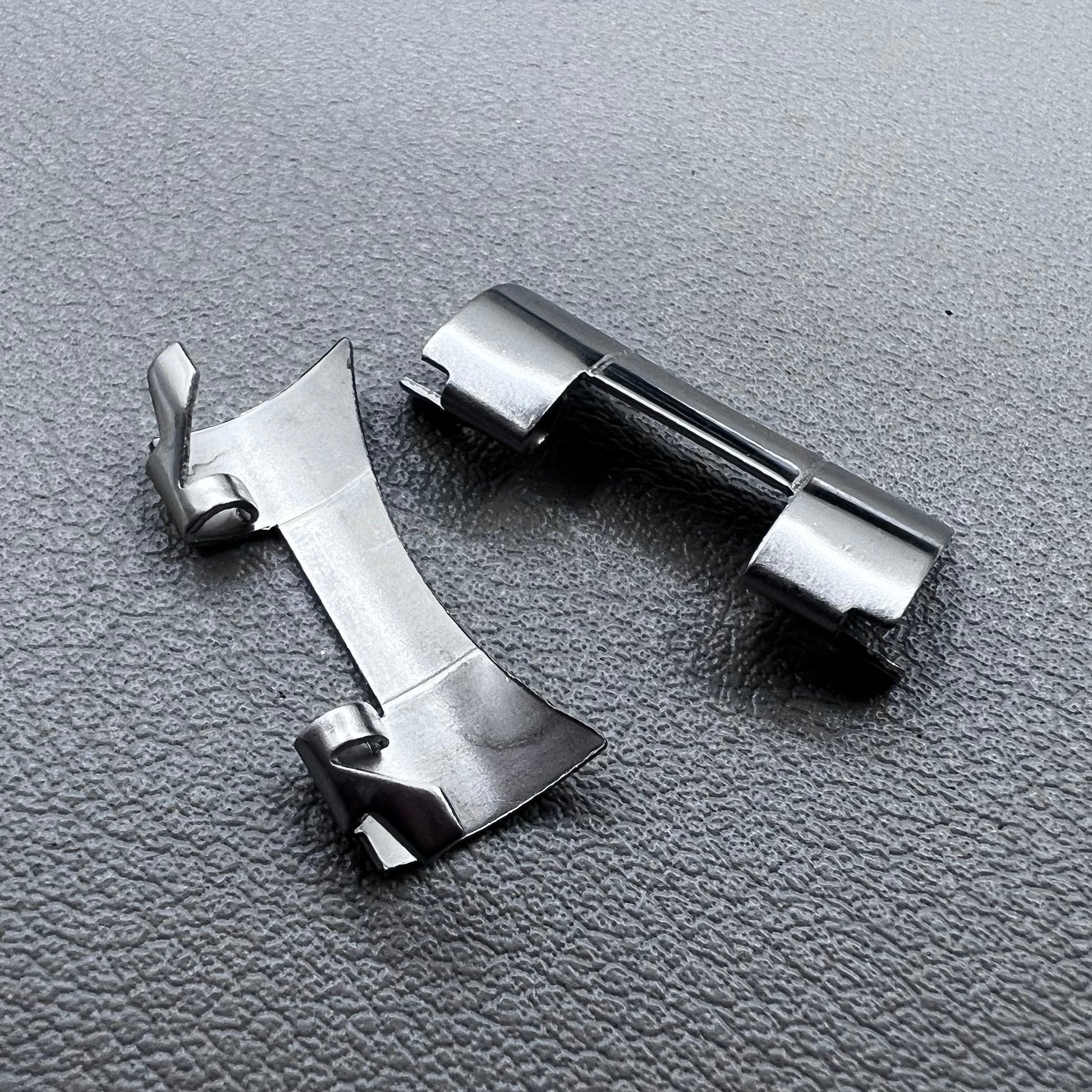 Set of 2 stainless steel 20x9mm curved end links and spring bars for watch bands, compatible with various straps.