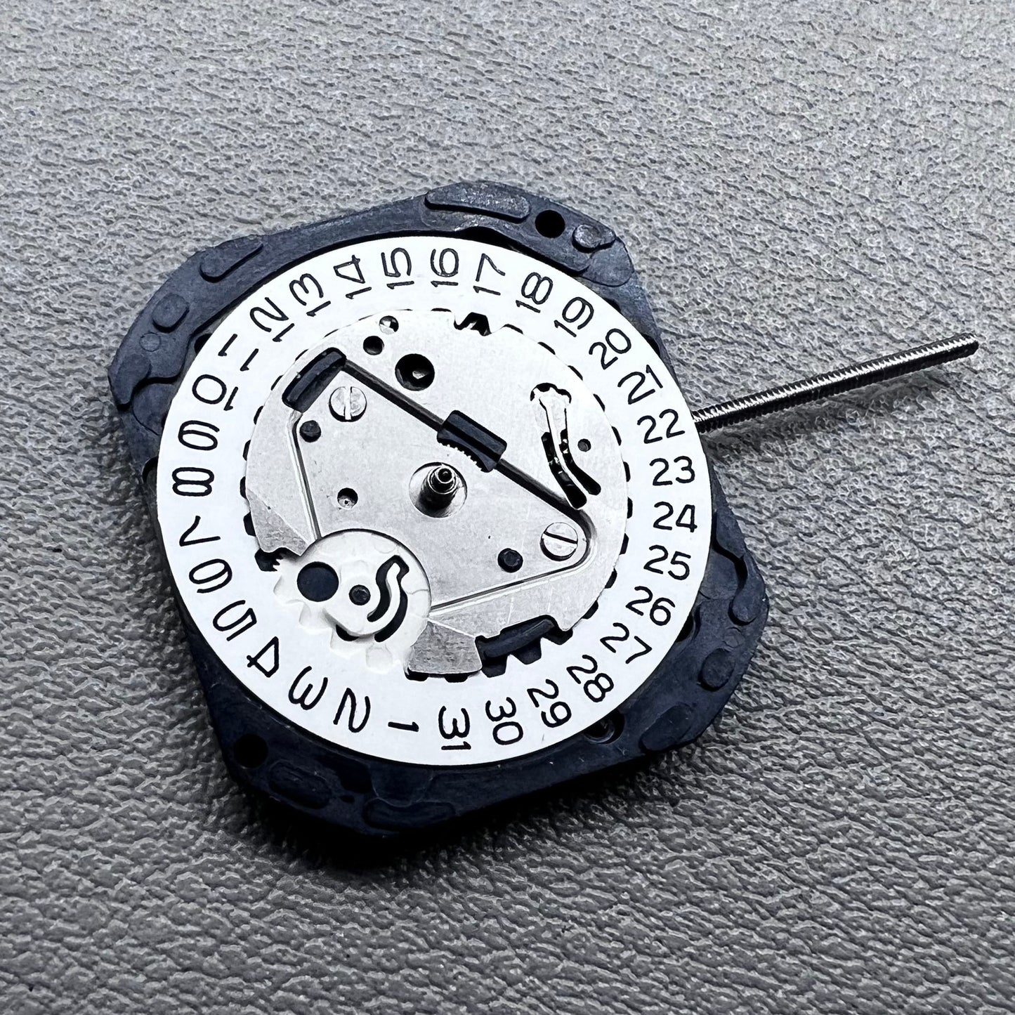 Japan VX22 quartz watch movement with date at 3 o'clock, white disk replacement for precision.