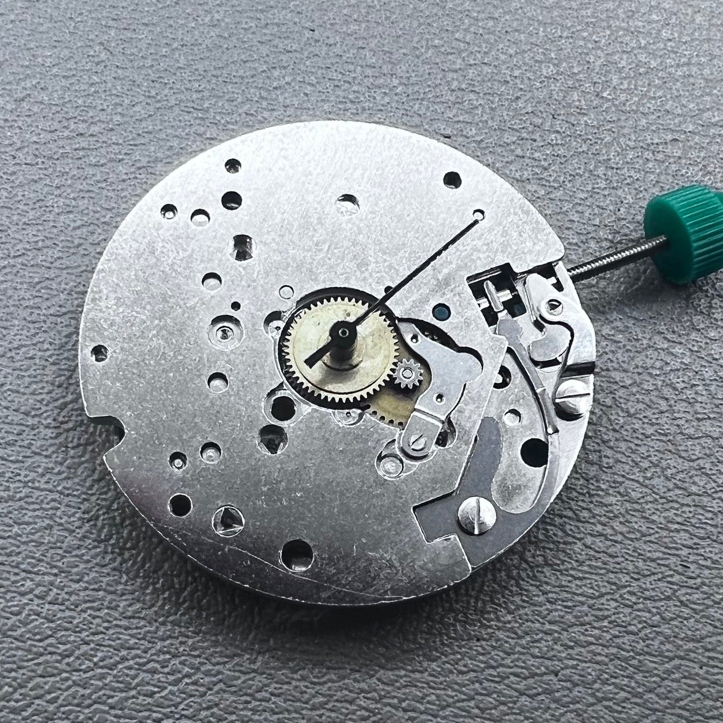 Swiss ETA 6640B quartz watch movement with 3 hands and black circuit board for precise timekeeping.