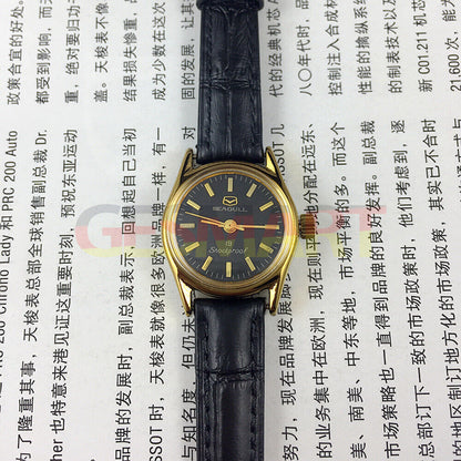 Tianjin Seagull black round ladies watch with gold nail markers and manual mechanical movement for elegant wear.