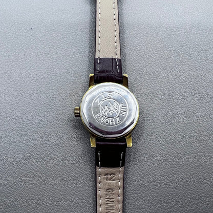 Dark Brown Strap Round Case 3 Hands Purple Background Manual Mechanical Watch