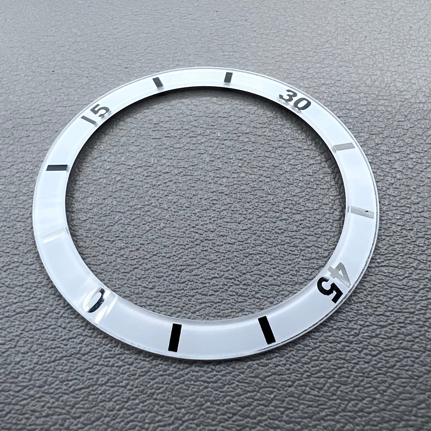 White 36mm ceramic watch bezel insert with numeral markings for men's and women's watches.