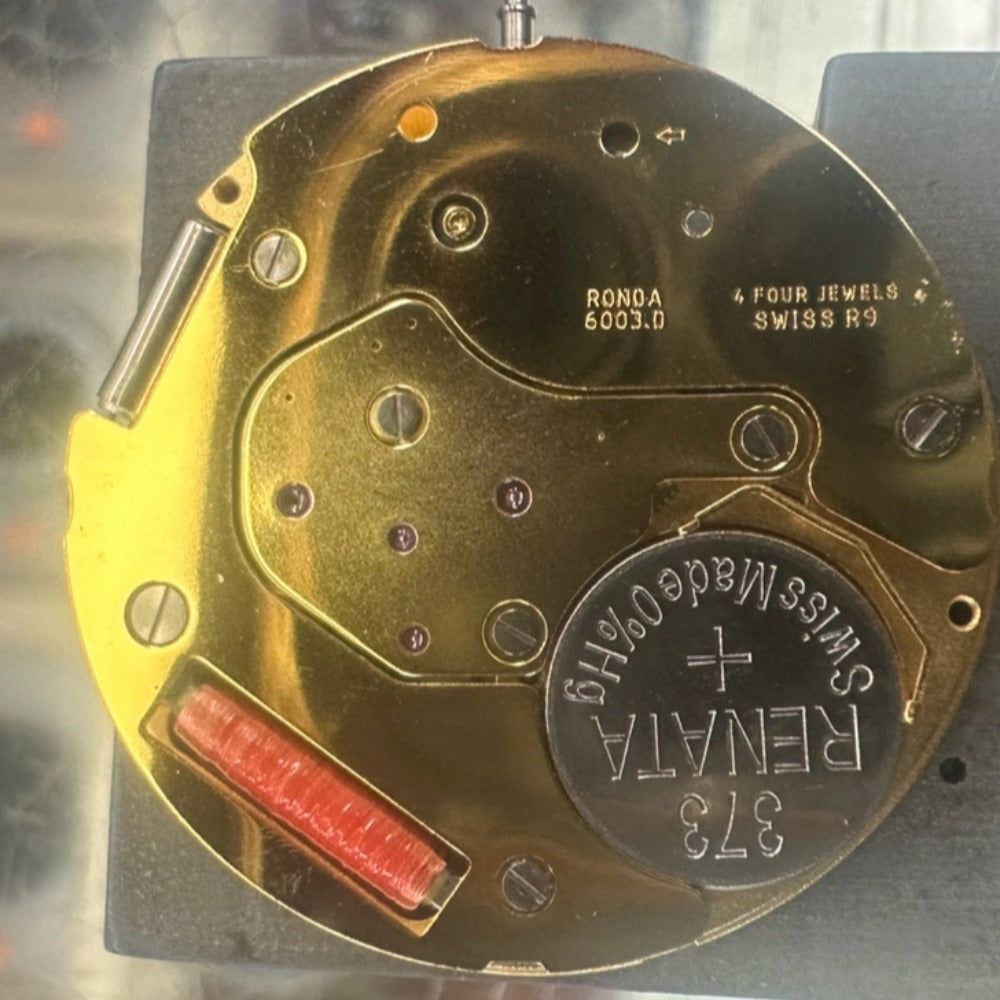 Swiss Made Ronda 6003.D quartz watch movement with single calendar, black disk, and 3 hands.
