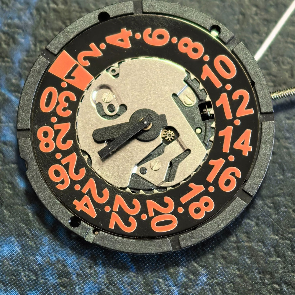 Swiss ISA 2320 quartz watch movement with 3 hands, black disk, and orange font date at 3.