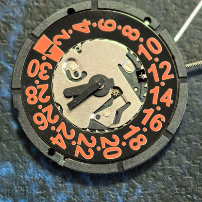 Swiss ISA 2320 quartz watch movement with 3 hands, black disk, and orange font date at 3.