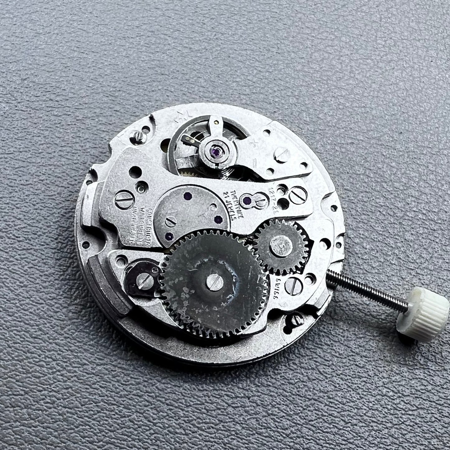 Disassembled Swiss RONDA MATIC 1217-21 manual winding watch movement showcasing intricate components.