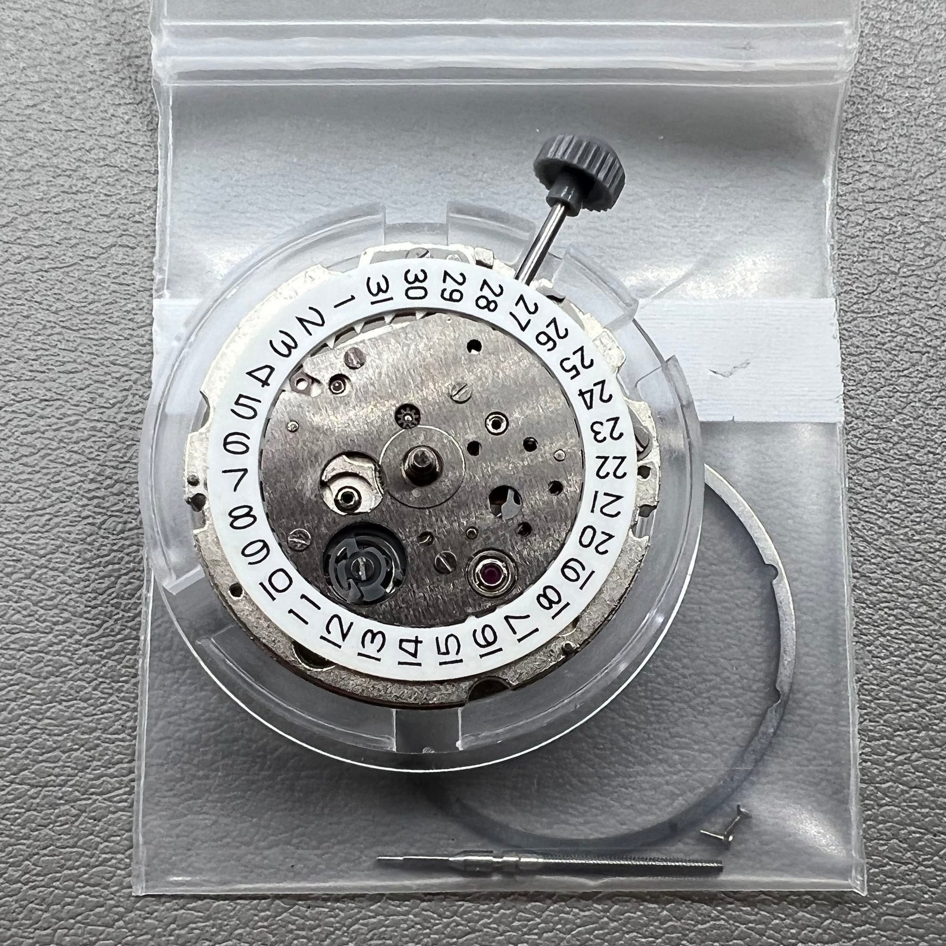 Japan Miyota 8218 automatic watch movement with date at 9 o'clock and two hands, precision timekeeping.