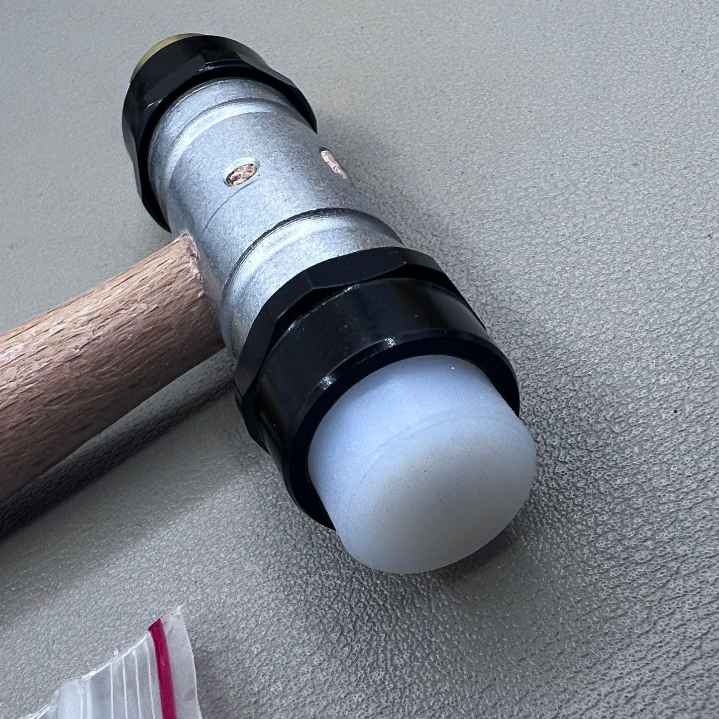 Swiss Tool Bergeon 30417 hammer with replaceable brass and synthetic ends for delicate watch repair tasks.