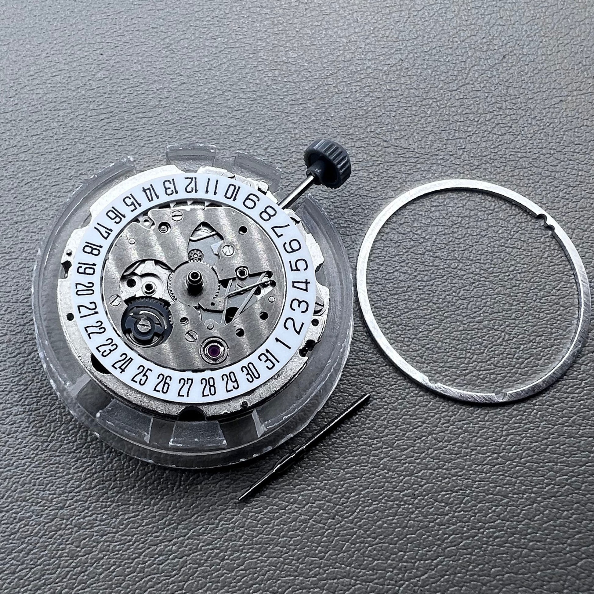 Japan Miyota 8215 silver plated automatic watch movement with date at 6 o?clock, precise mechanical design.
