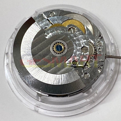 Shanghai 2824 automatic watch movement with silver carved design and date display at 3 o'clock.