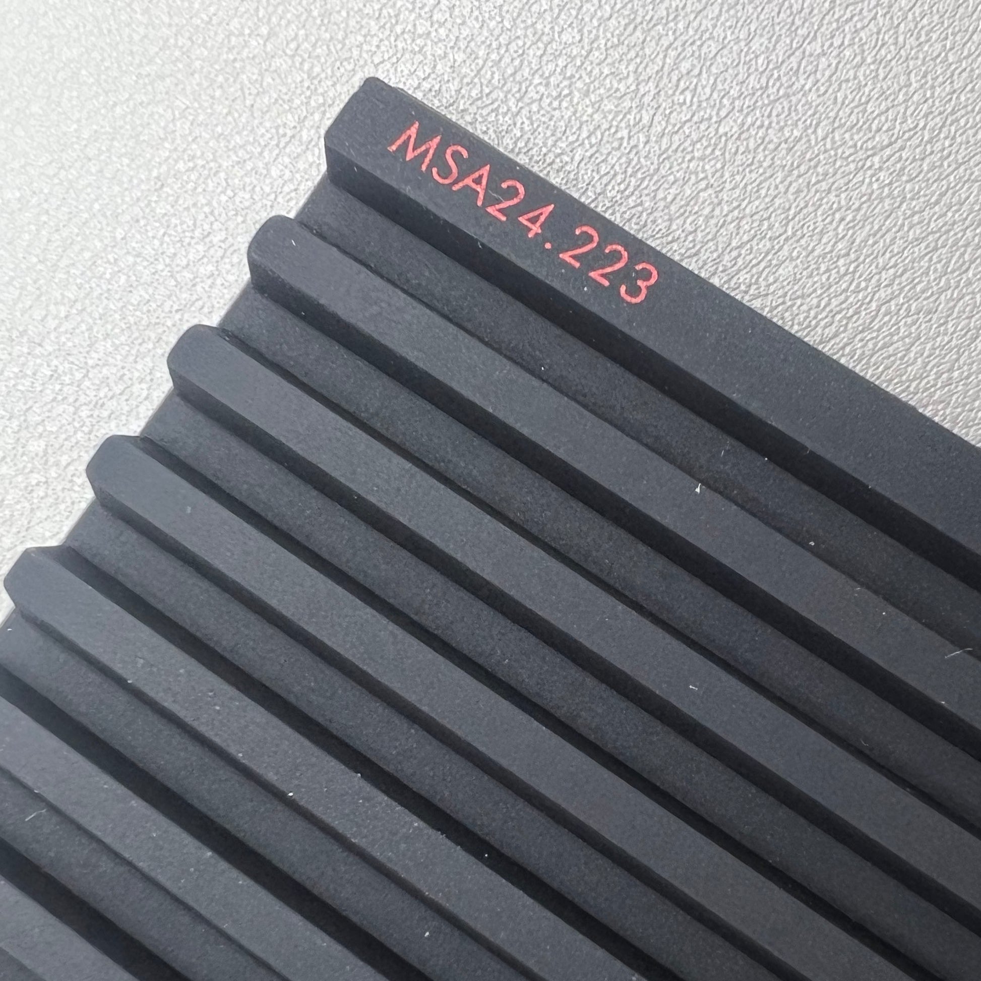 Swiss Horotec black silicon anti-slip bench mat with 32 grooves, ideal for watch repair tools organization.