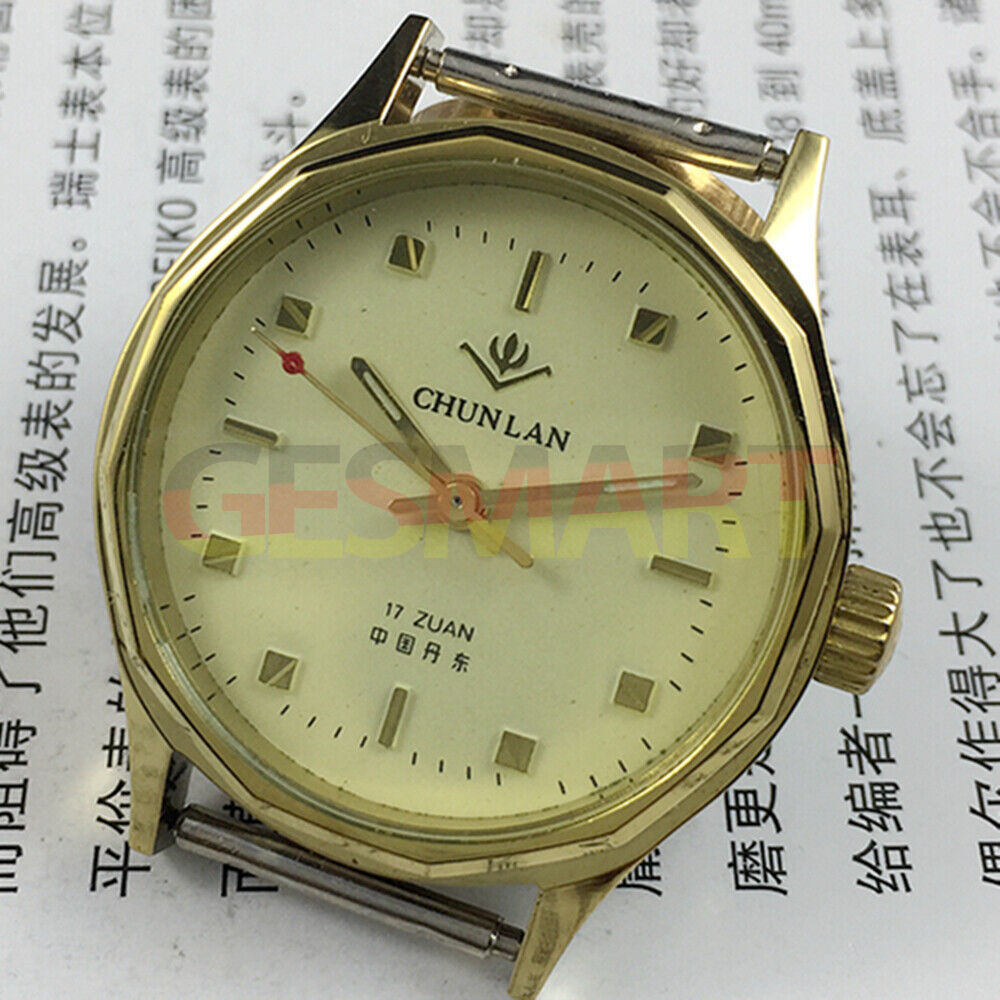 32mm China manual mechanical watch with 17 jewels, yellow dial, green lume hands.