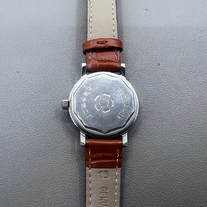 Light brown Shanghai manual mechanical watch with single calendar, 17 jewels, shock-resistant design for durability.