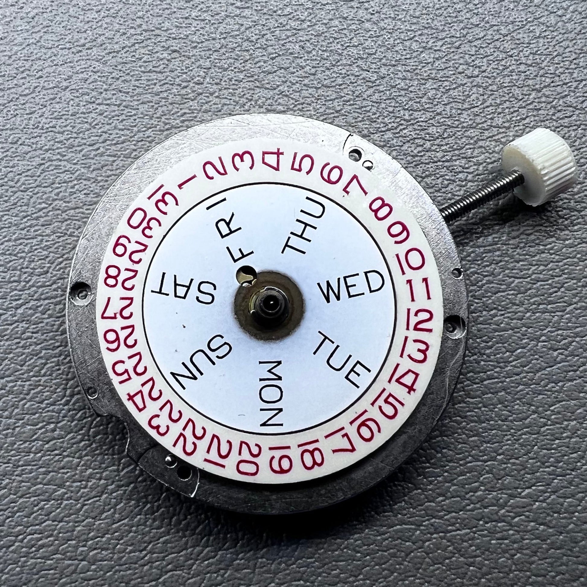 Disassembled Swiss RONDA MATIC 1217-21 manual winding watch movement showcasing intricate components.