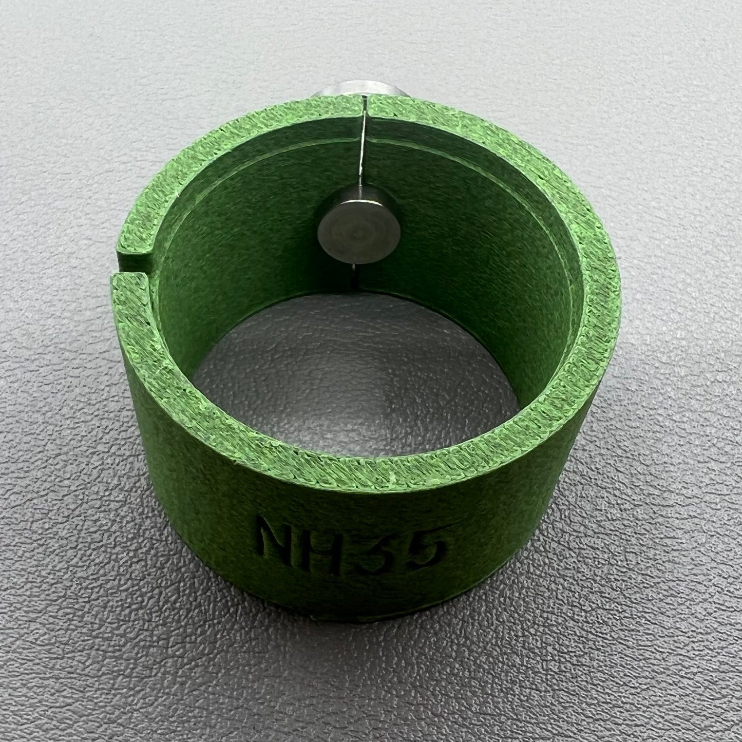 Watch movement holder securely holding Seiko NH35 movement for precise assembly and repair.
