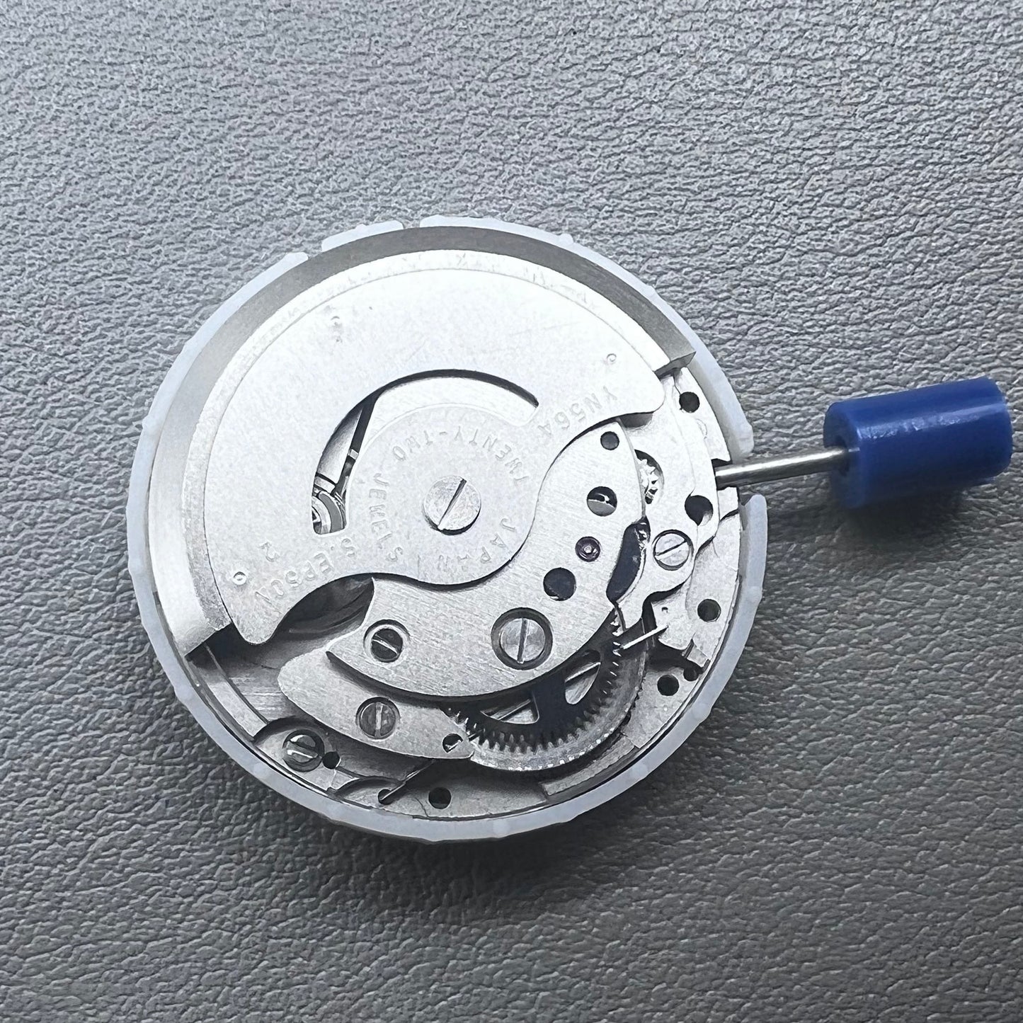 Japan Epson YN56 mechanical watch movement showing date and day display at 3 o'clock, precise and reliable.