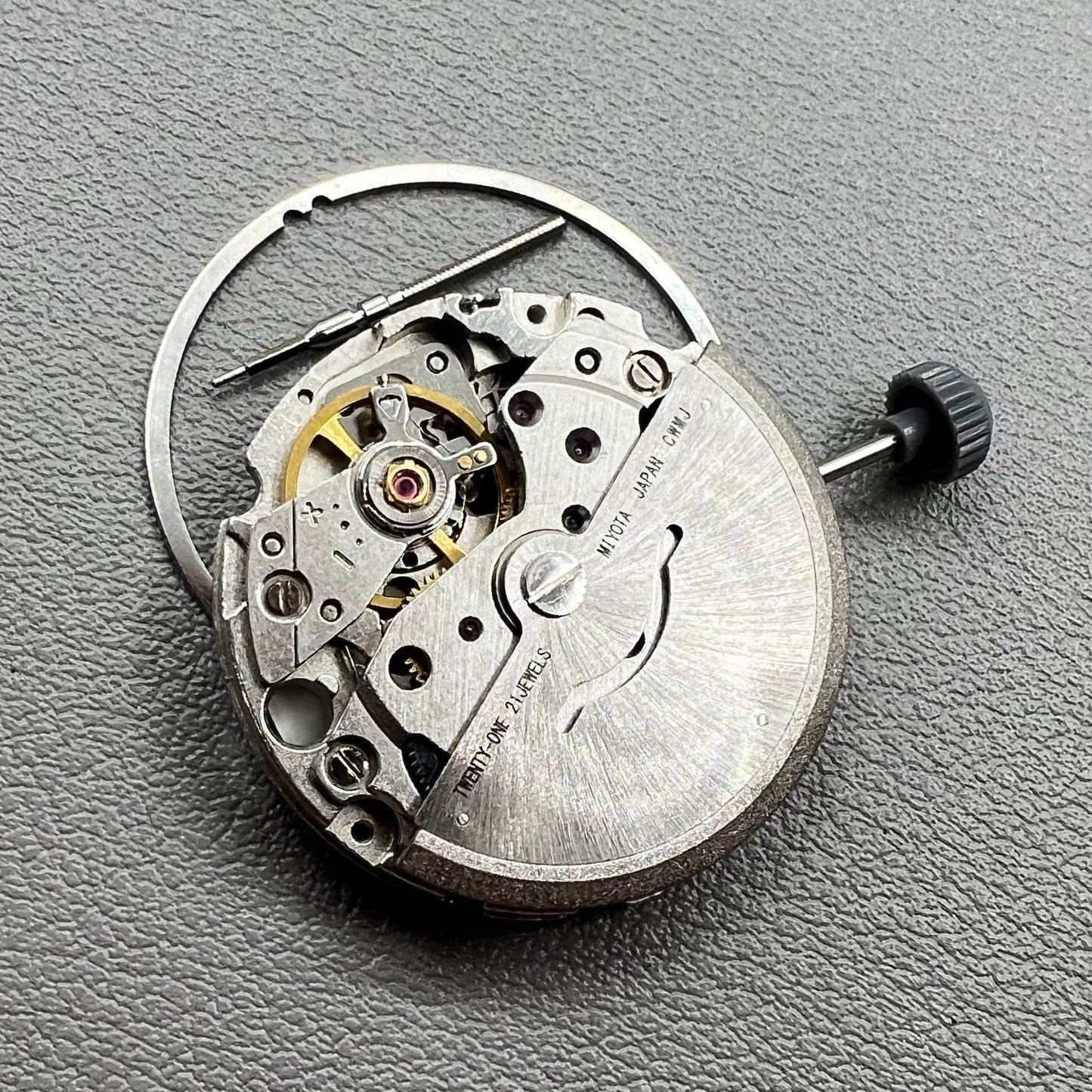 Close-up of Japan Miyota 8200 movement with single date display at 3 o'clock on watch accessory.