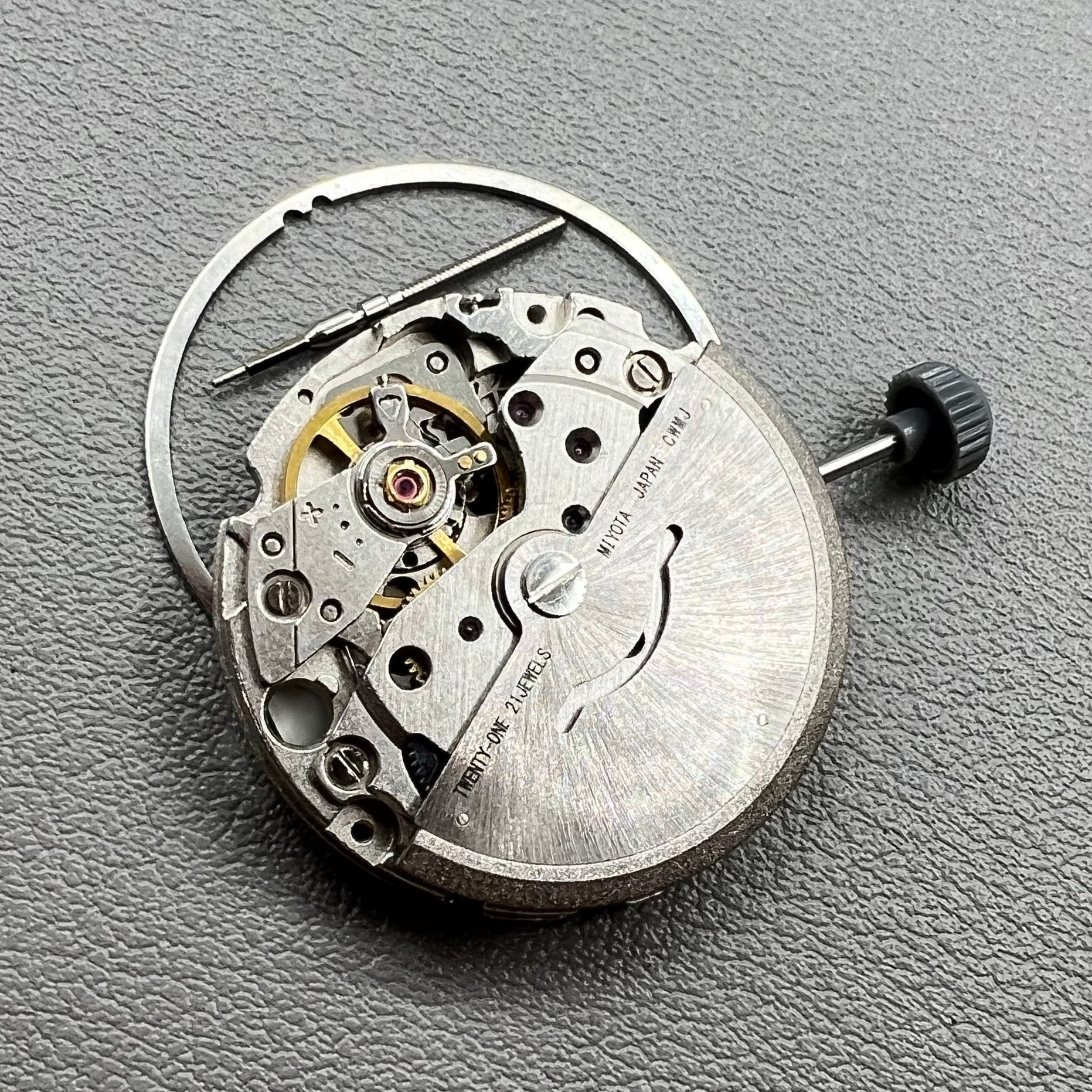 Close-up of Japan Miyota 8200 movement with single date display at 3 o'clock on watch accessory.