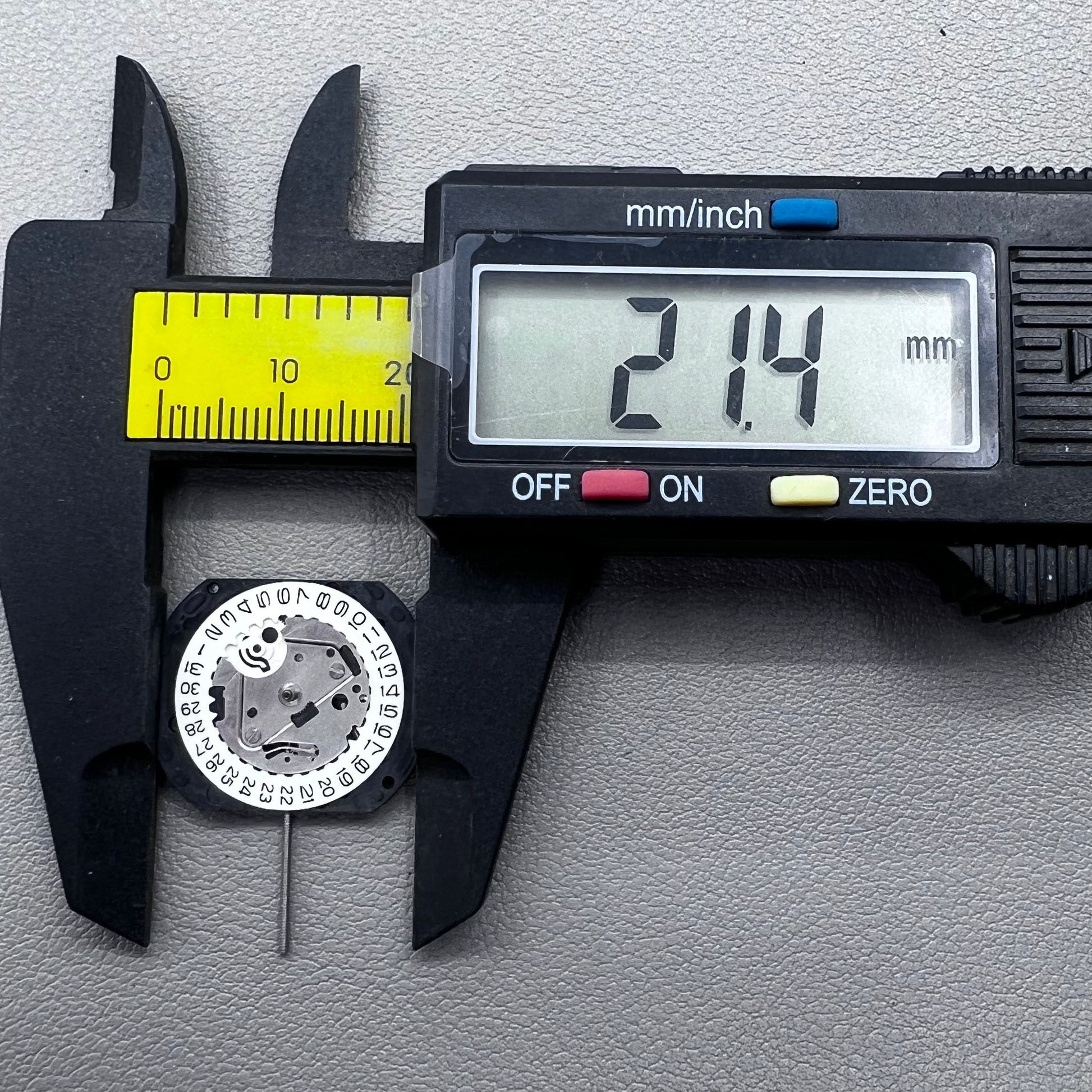 Japan VX22 quartz watch movement with date at 3 o'clock, white disk replacement for precision.