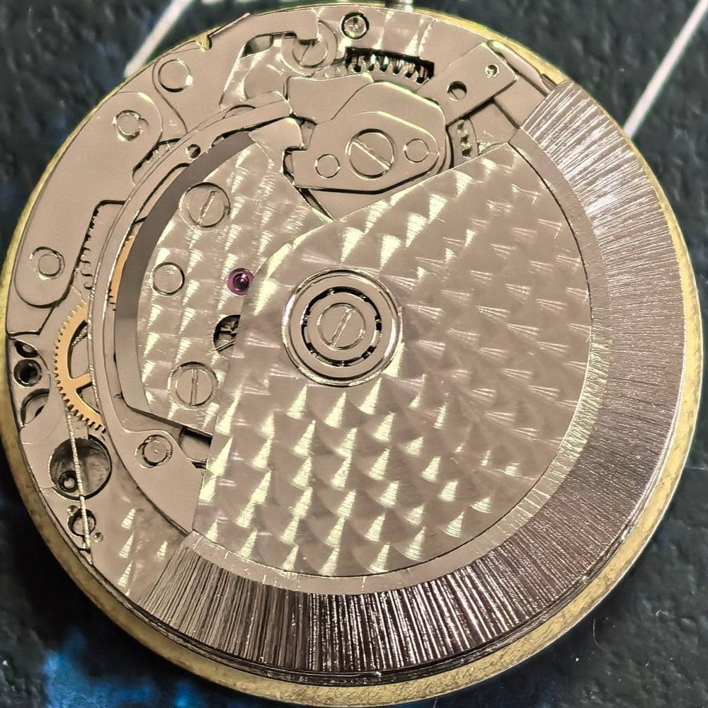 Chinese Dandong 7750 mechanical watch displaying single calendar, small seconds at 6, 9, and 12 o'clock positions.