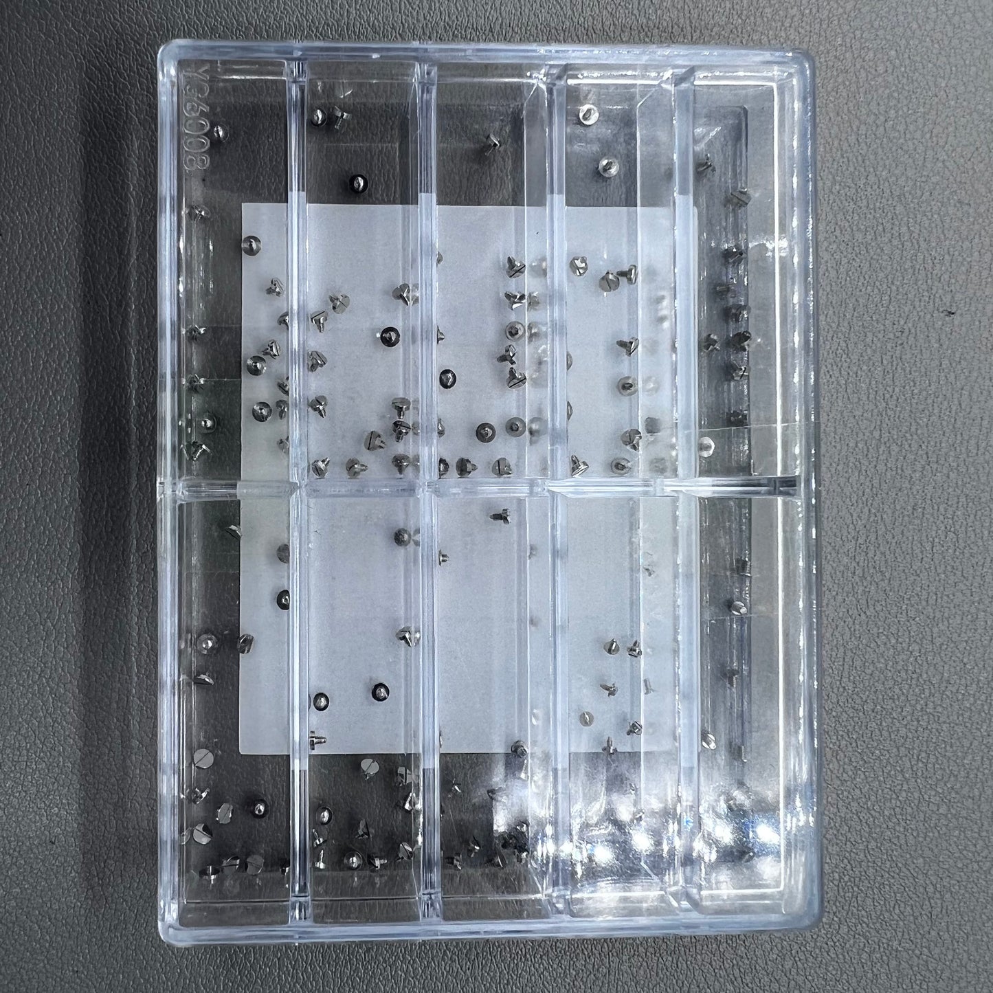 Replacement fixing screws for watch movements in assorted sizes, durable precision.