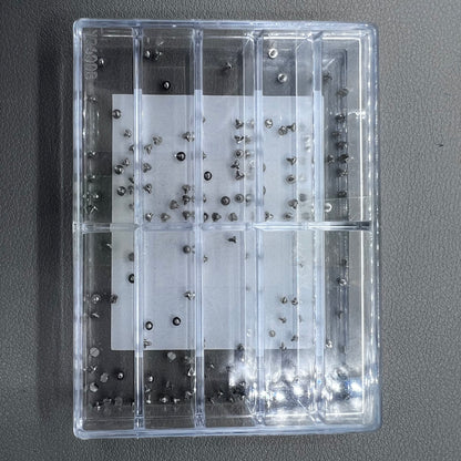 Replacement fixing screws for watch movements in assorted sizes, durable precision.