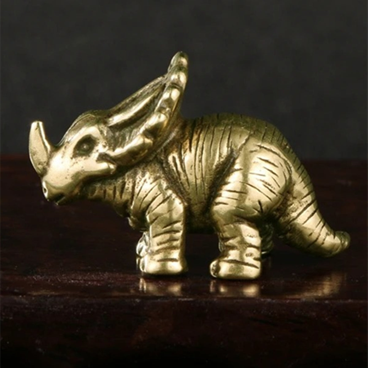 Hand-carved vintage copper horned dinosaur figurine, perfect for Jurassic-themed decor.