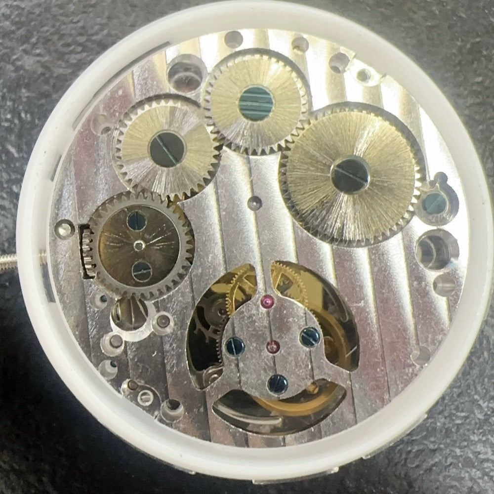 Dandong 9001 hand winding mechanical watch with visible flywheel and two hands, premium craftsmanship.