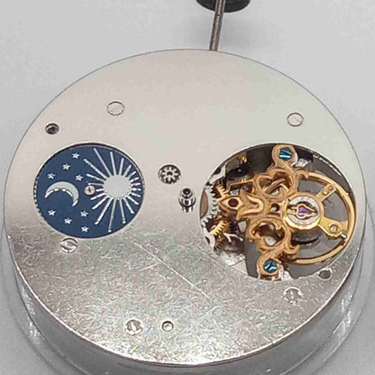 Silver watch accessory with mechanical movement, moonphase at 12, large flywheel detail, China made.