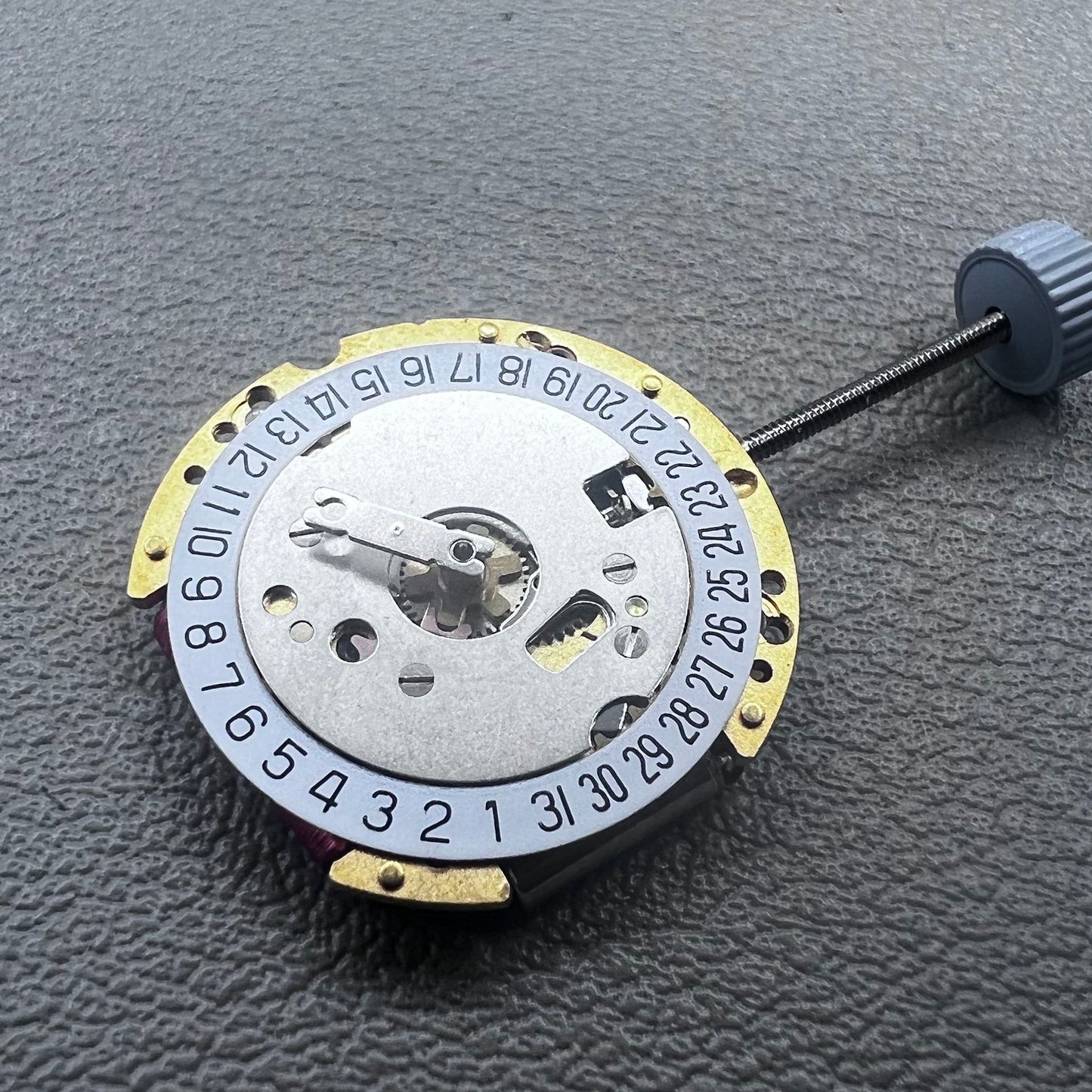 Swiss Ronda 775 quartz watch part with white date disk at 6 o'clock, ideal for precise repairs.