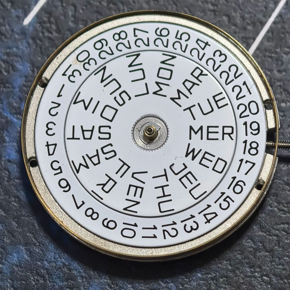 FE France Ebauche 7220-22 quartz watch movement with day, date display, and crown at 4 o?clock position.
