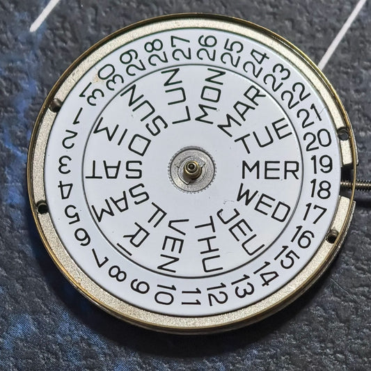 FE France Ebauche 7220-22 quartz watch movement with day, date display, and crown at 4 o?clock position.
