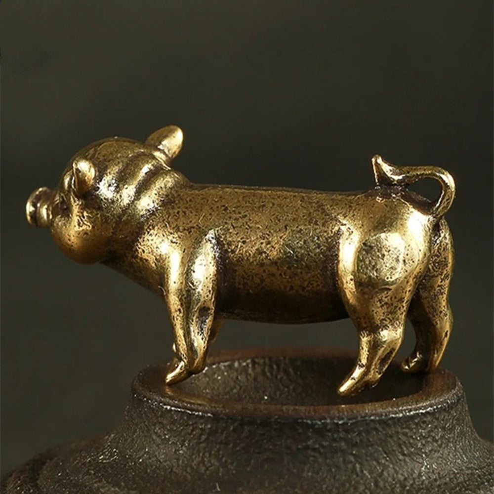 Hand-carved vintage solid copper pig figurine for elegant watch accessory display.