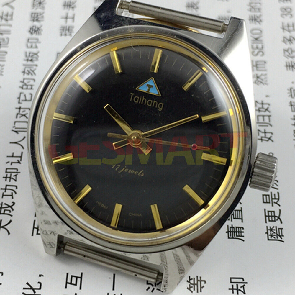 Chinese Taihang 32mm manual mechanical watch with 17 jewels, black dial, and golden nail markers.