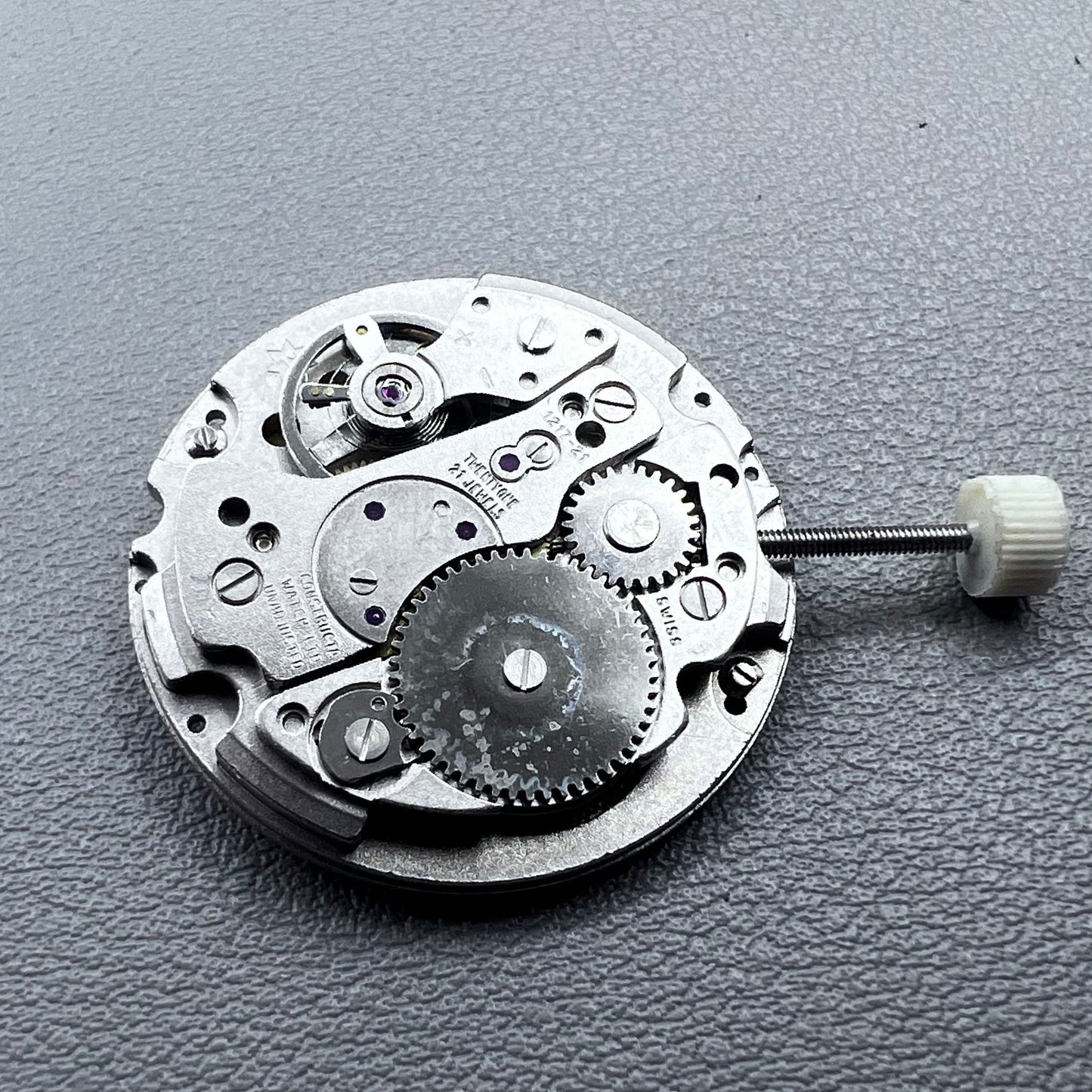 Disassembled Swiss RONDA MATIC 1217-21 manual winding watch movement showcasing intricate components.