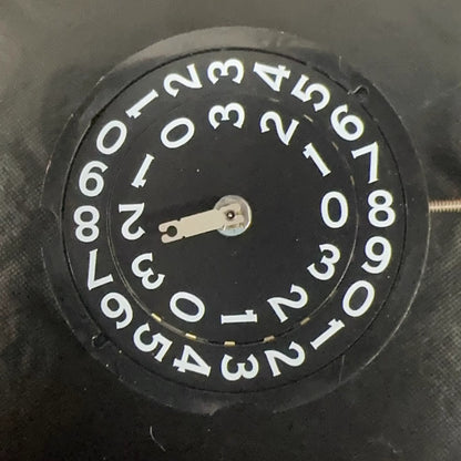 Swiss Made RODNA 509 black disk watch part with quartz movement and date display at 3 o'clock.