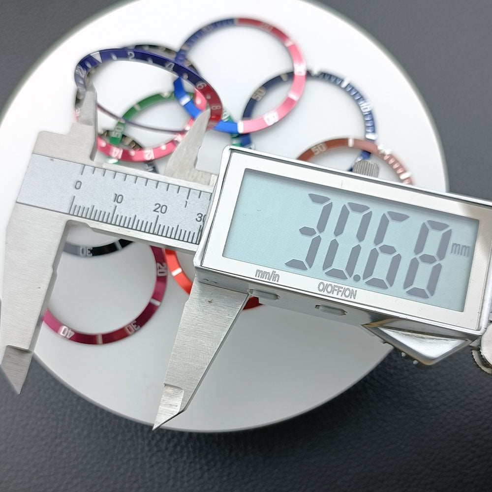 Green lume aluminum watch bezel with red slope and white font, 36.5x30.7mm, ideal for watch customization.