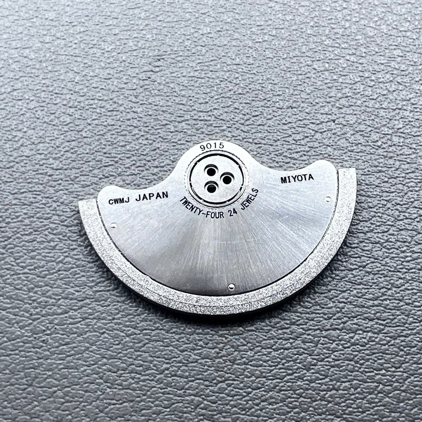 Silver rotor oscillating weight for Miyota 9015 mechanical watch movement, enhancing winding efficiency.