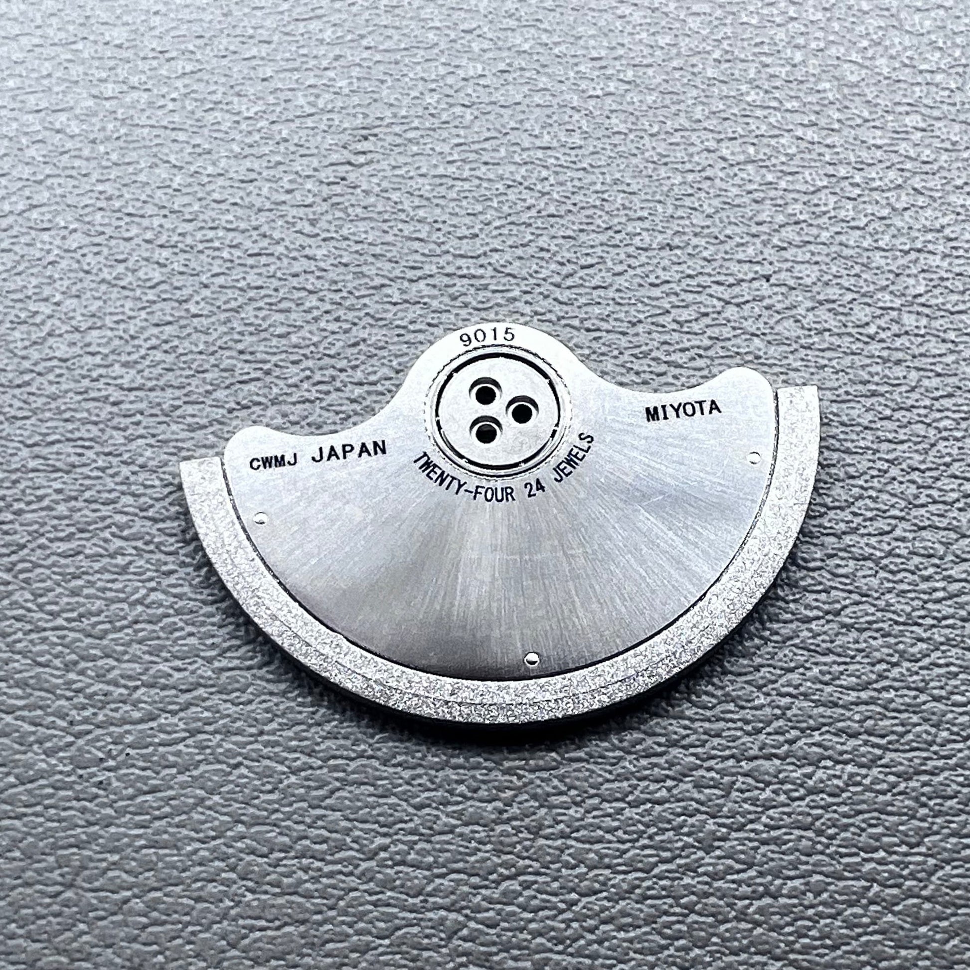 Silver rotor oscillating weight for Miyota 9015 mechanical watch movement, enhancing winding efficiency.