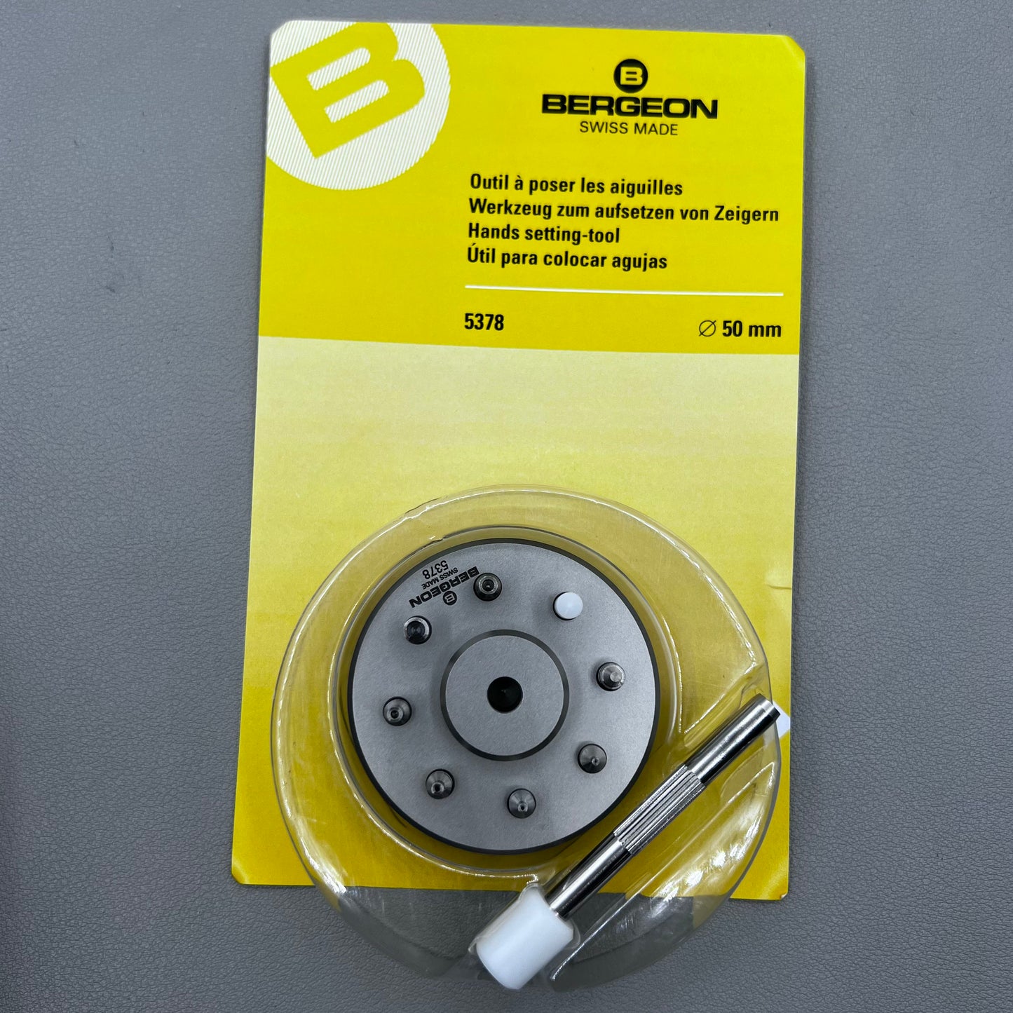 Swiss Bergeon 5378 watch hand fitting tool with 9 stakes on holder for precise hand installation.