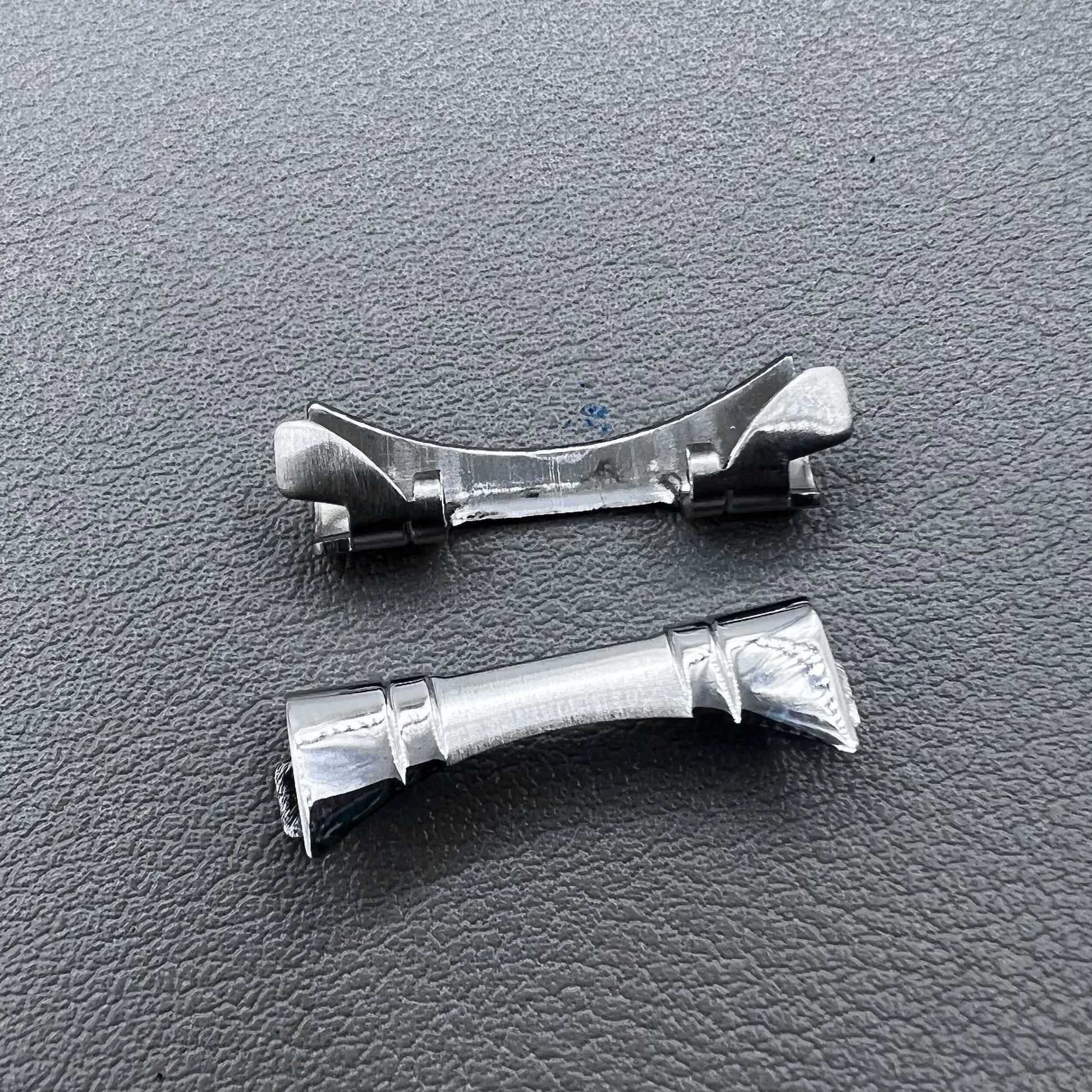 Polished curved end links spring bars set by for watch band strap replacement.