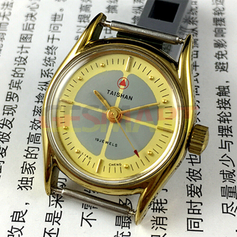TAISHAN mechanical lady watch with 19 jewels, yellow-grey dial, round golden case, elegant design.