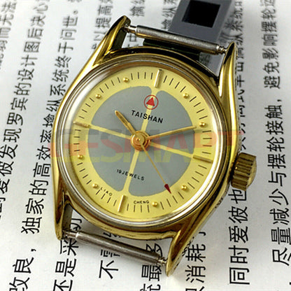 TAISHAN mechanical lady watch with 19 jewels, yellow-grey dial, round golden case, elegant design.
