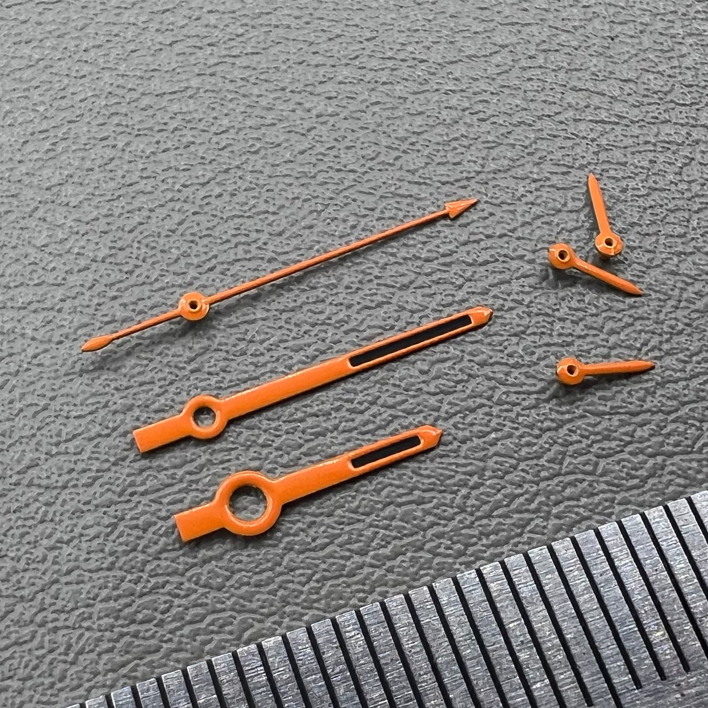 Orange-trimmed black watch hands with green lume, compatible with VK63 movement, perfect for precise timekeeping.