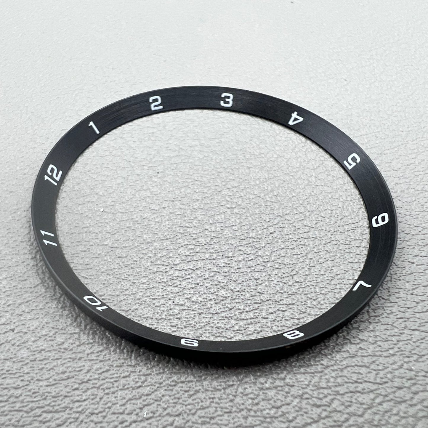 Black stainless steel chapter ring 34.9mm x 31.0mm x 1.9mm for watch accessory.