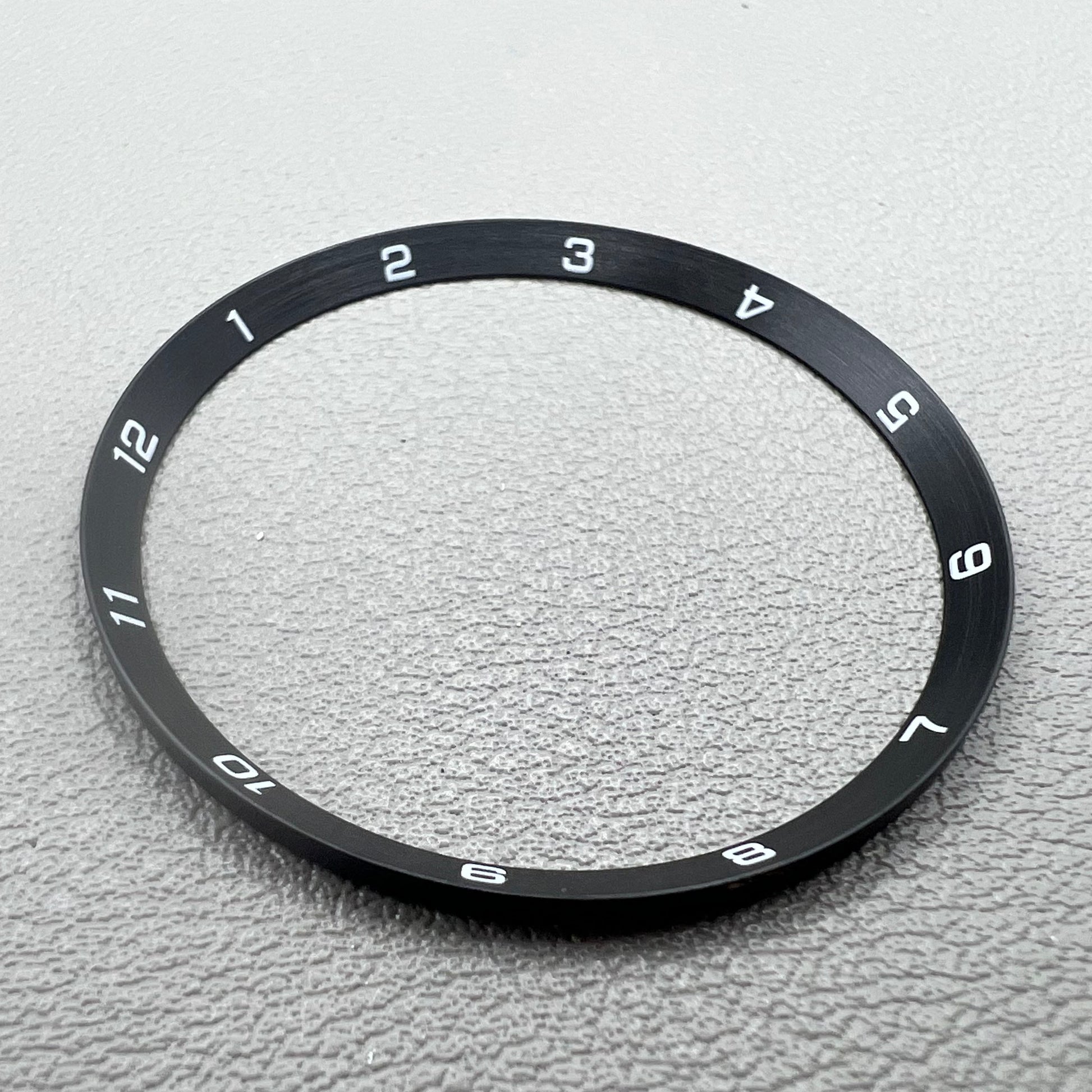 Black stainless steel chapter ring 34.9mm x 31.0mm x 1.9mm for watch accessory.