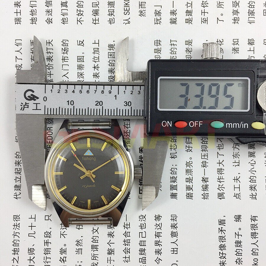 Chinese Taihang 32mm manual mechanical watch featuring black dial, golden nail markers, and 17 jewels for precision timekeeping.