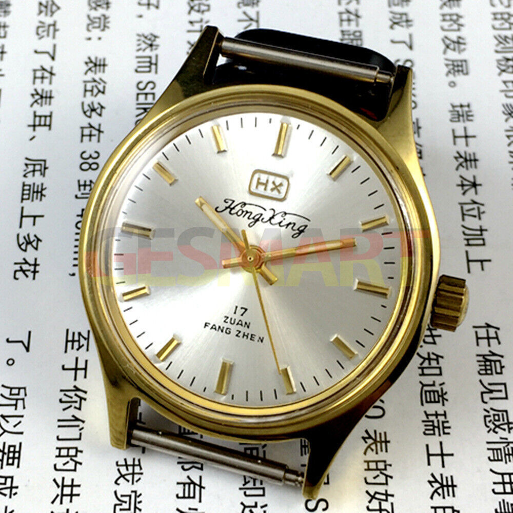 33mm China-made manual mechanical watch with golden hour markers and silver dial, shock-resistant design.